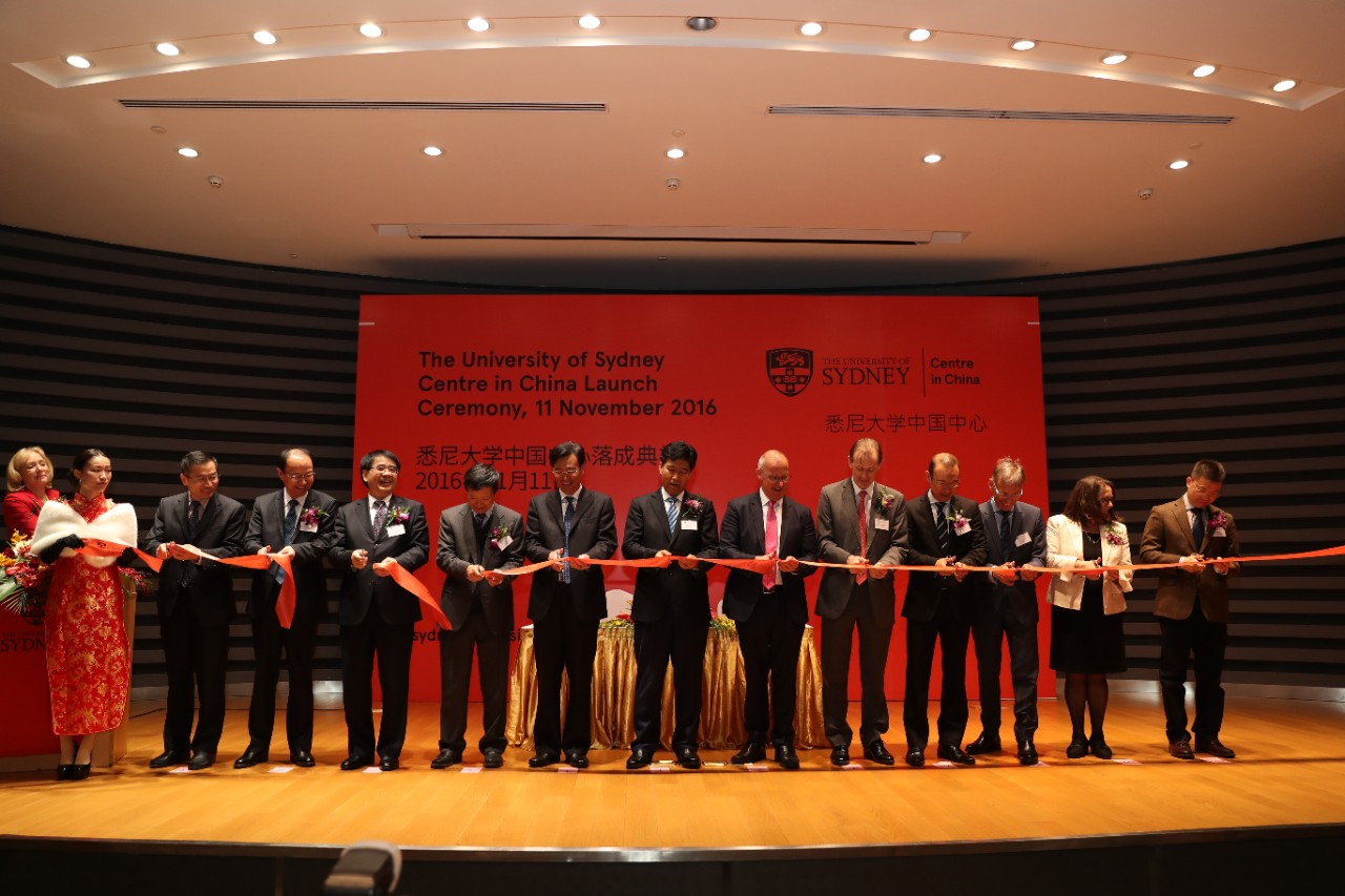 The ribbon cutting ceremony at the Centre in China launch. From left-right: Mr Ding Lixin (Deputy Chairman, Suzhou Industrial Park Administrative Committee), Mr Zhou Changkui (Deputy Administrator, State Administration of Foreign Experts Affairs), Prof. Zhang Laiwu (Former Vice-Minister, Ministry of Science and Technology), Mr Guo You (Chairman of Board of Supervisors, China Construction Bank), Mr Wang Xiang (Deputy Mayor of Suzhou and Secretary of the CPC Suzhou Industrial Park Working Committee), Mr Qu Futian (Mayor of Suzhou Municipal Government), Dr Michael Spence (Vice-Chancellor and Principal, The University of Sydney), Mr Graeme Meehan  (Australian Consul General in Shanghai), Robert Kok (Councilor, City of Sydney and Advisory Panel member, China Studies Centre, The University of Sydney), Professor Jeffrey Riegel (Director, China Studies Centre, The University of Sydney), Cathryn Hlavka (Executive Director, The University of Sydney Centre in China) and Chen Dali (Director of International Relations, Ministry of Education).