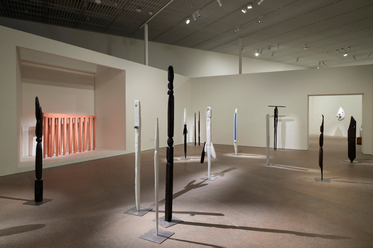 a room full of artworks, they look like colourful poles