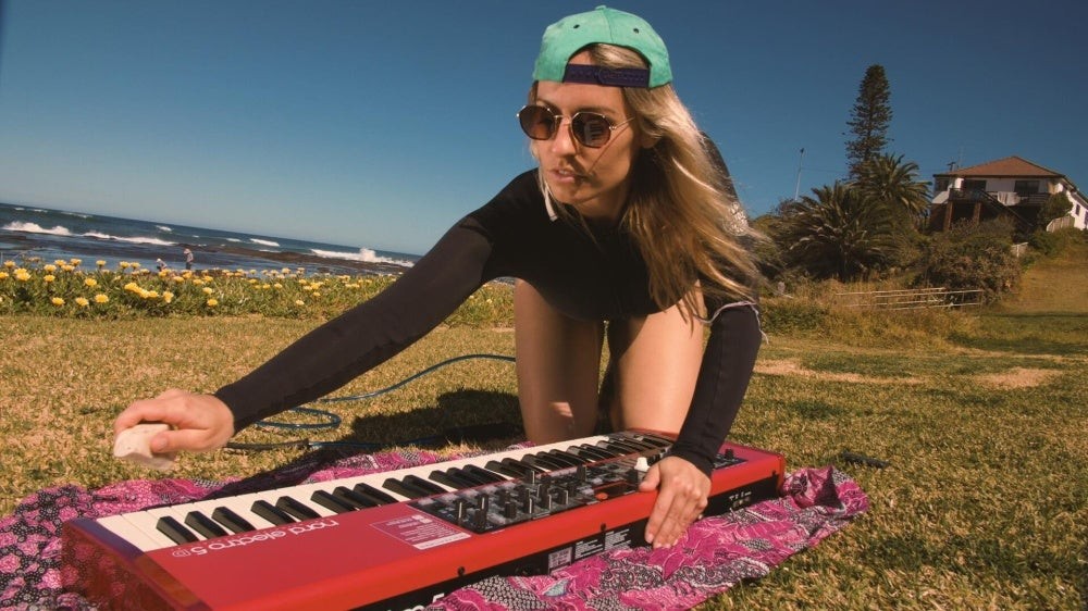 a woman at the beach with a piano keyboard