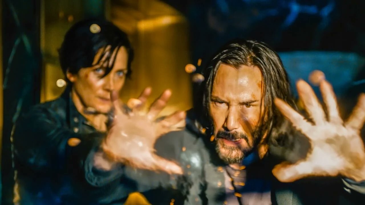 photo of two actors in The Matrix, they are looking at something closely