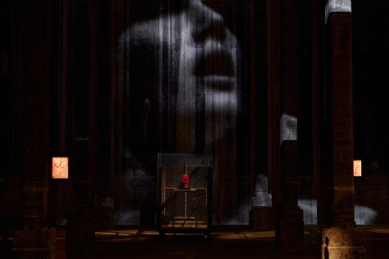 a dark room with art works inside, barely visible