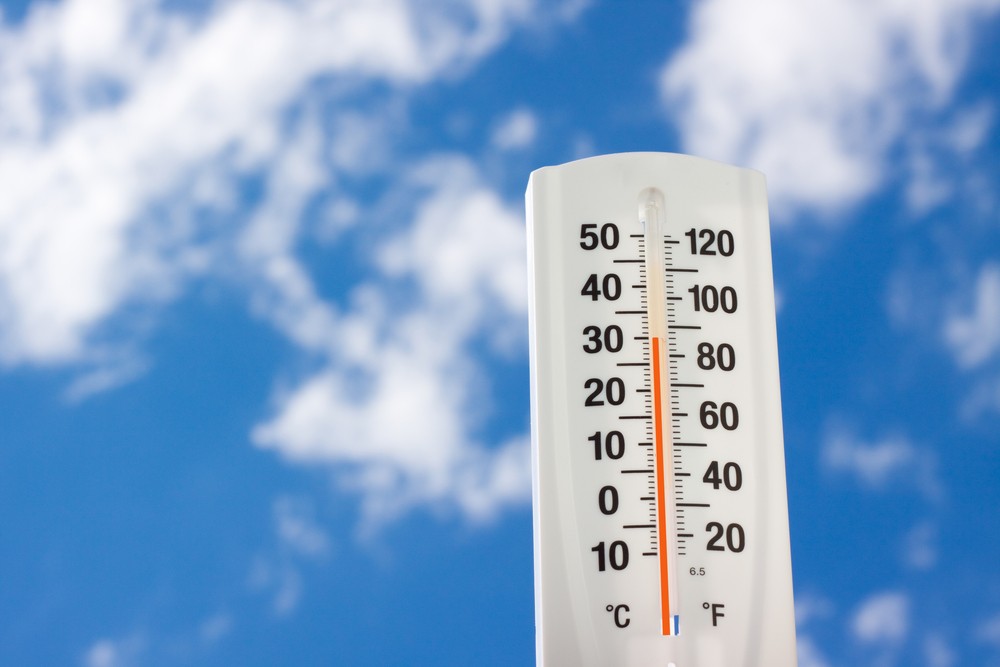 Thermometer showing rising temperatures with blue sky behind