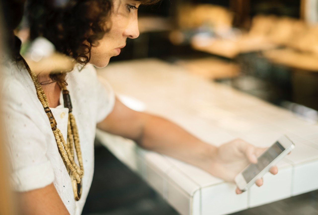 A woman using a smartphone. Image rawpixel.com/Unsplash