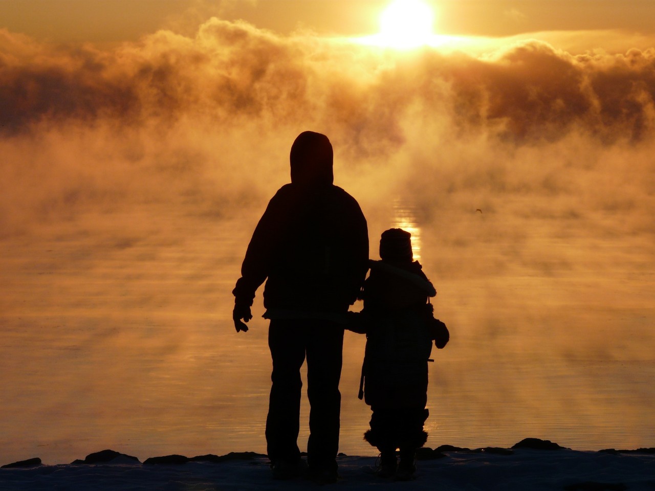 Father and son holding hands.