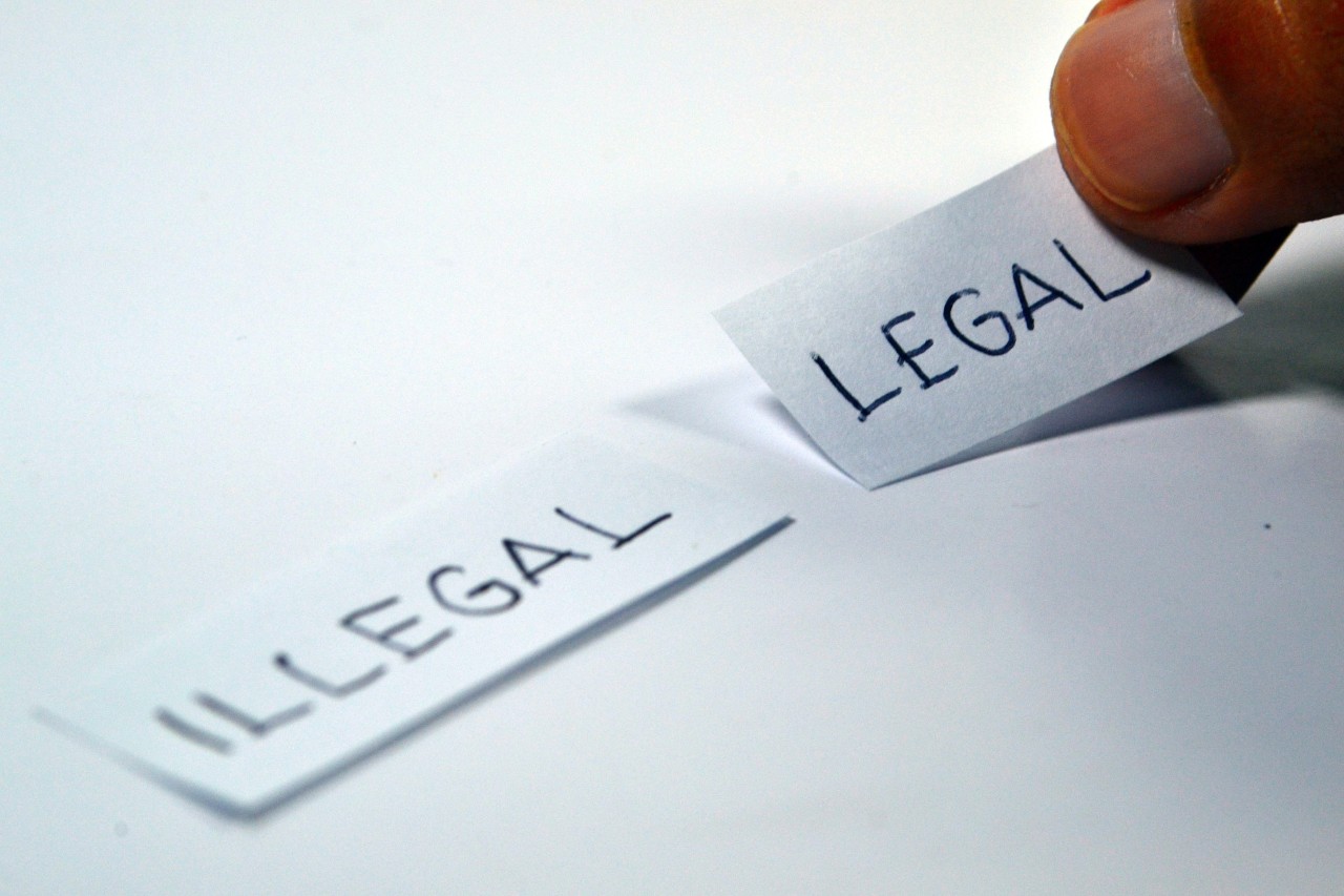 Pieces of paper with illegal and legal written on them