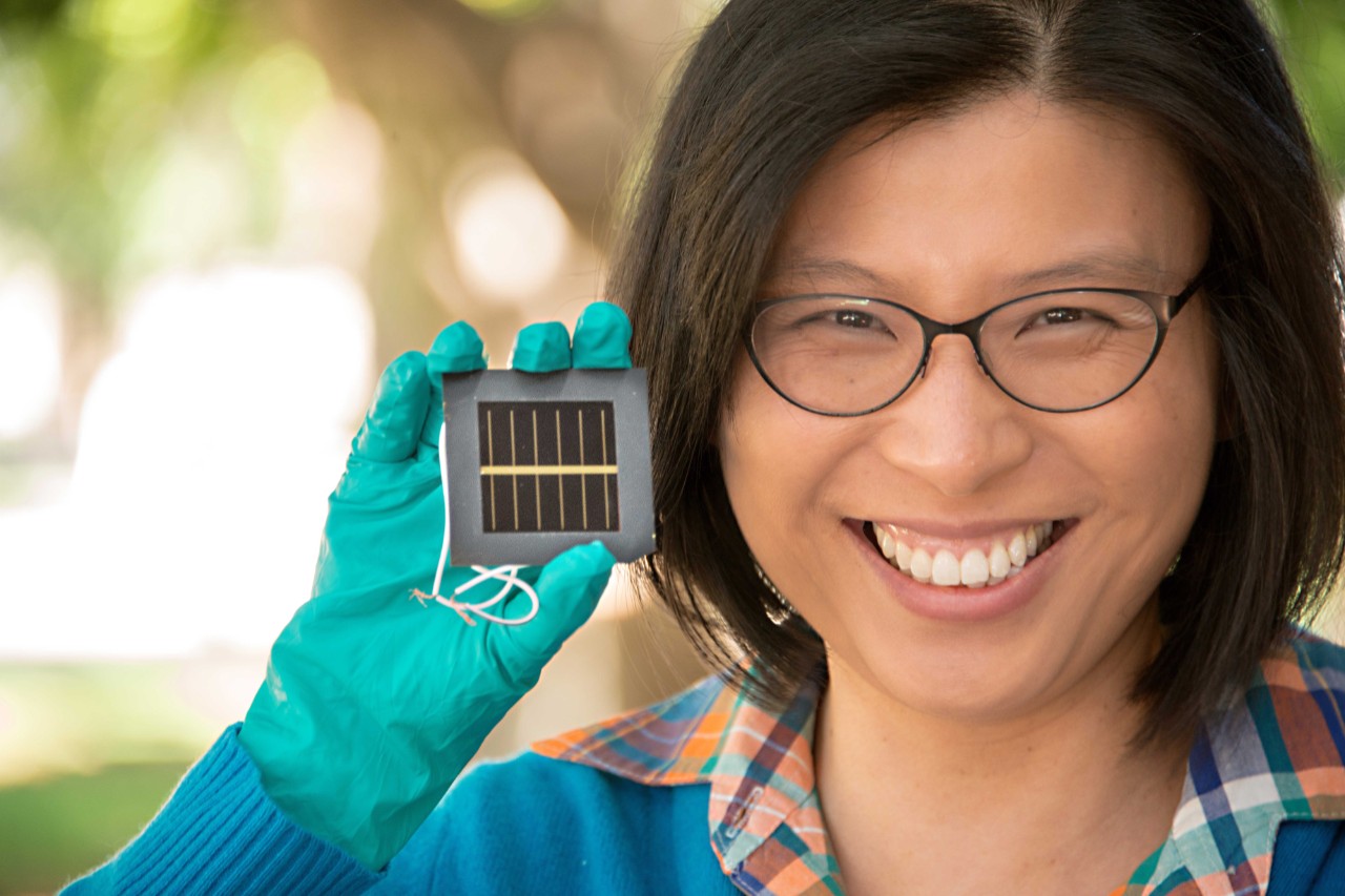 Associate Professor Anita Ho-Baillie holding a perovskite solar cell. Image courtesy UNSW.