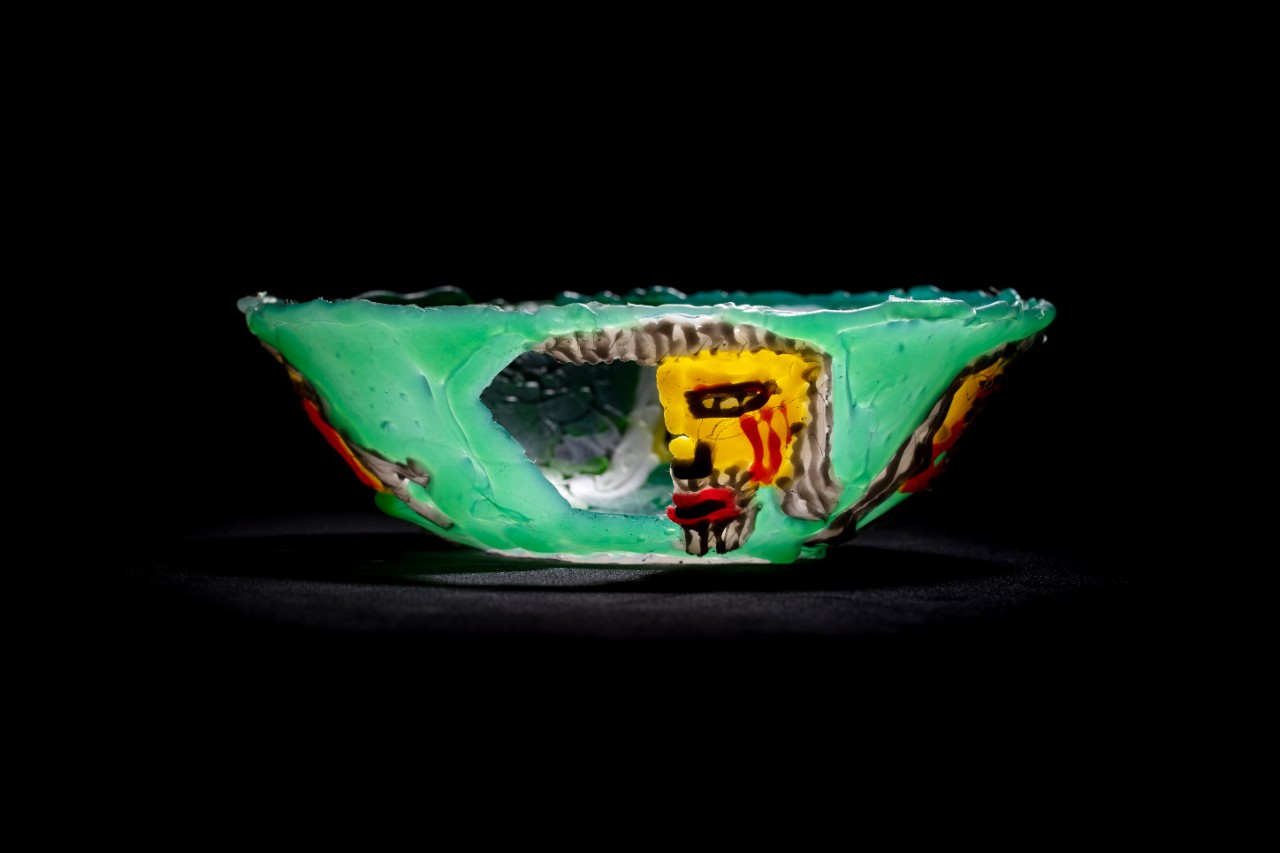 green bowl with faces 