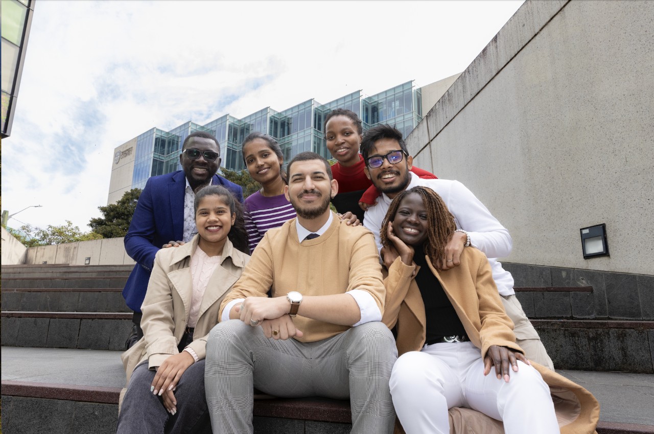 The seven Sydney International Equity Scholars sit together on campus.