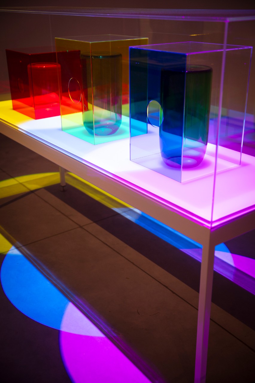 Coloured lights shining on coloured glass on an exhibition table