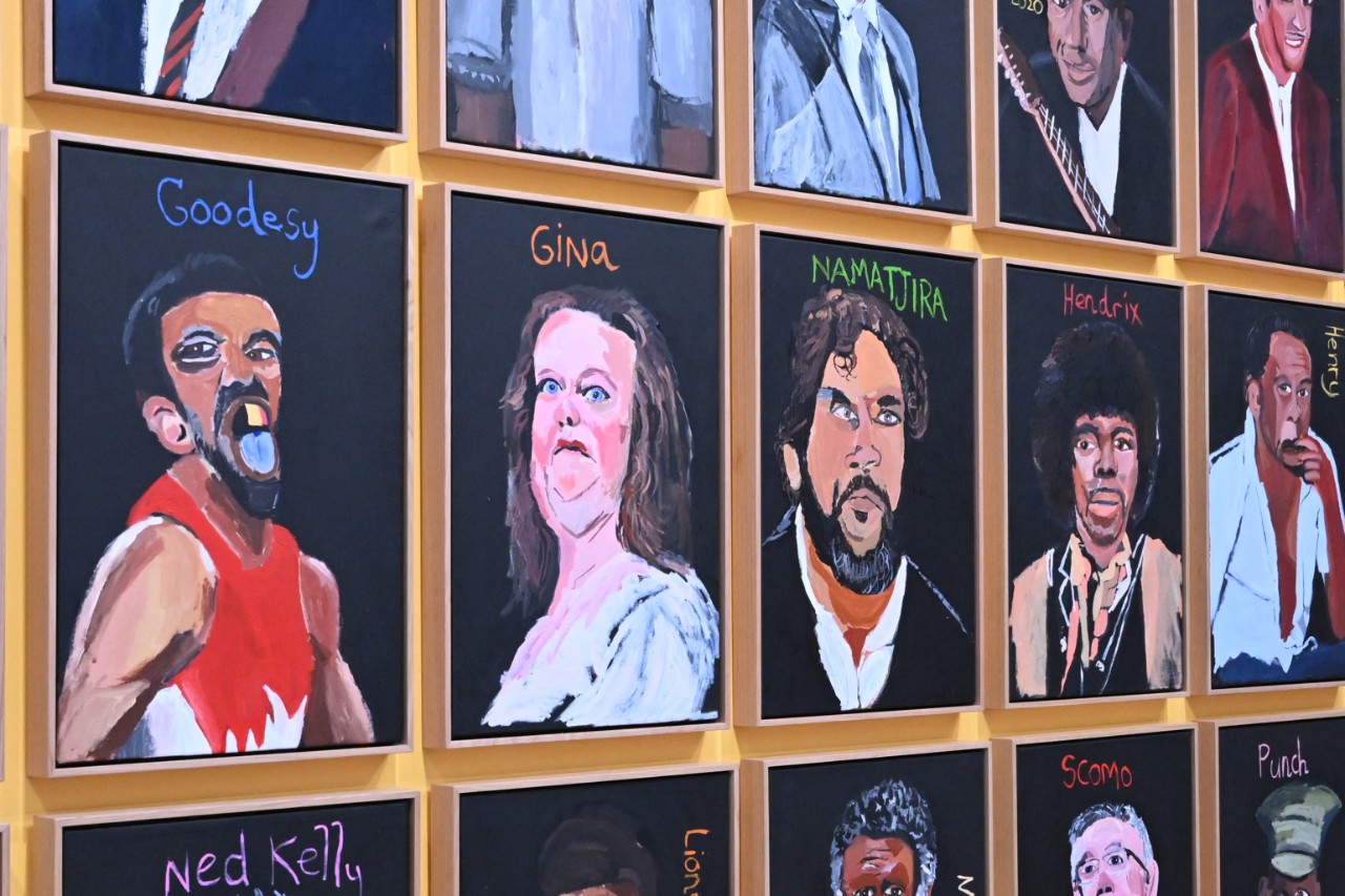 an art gallery wall with 14 paintings on it