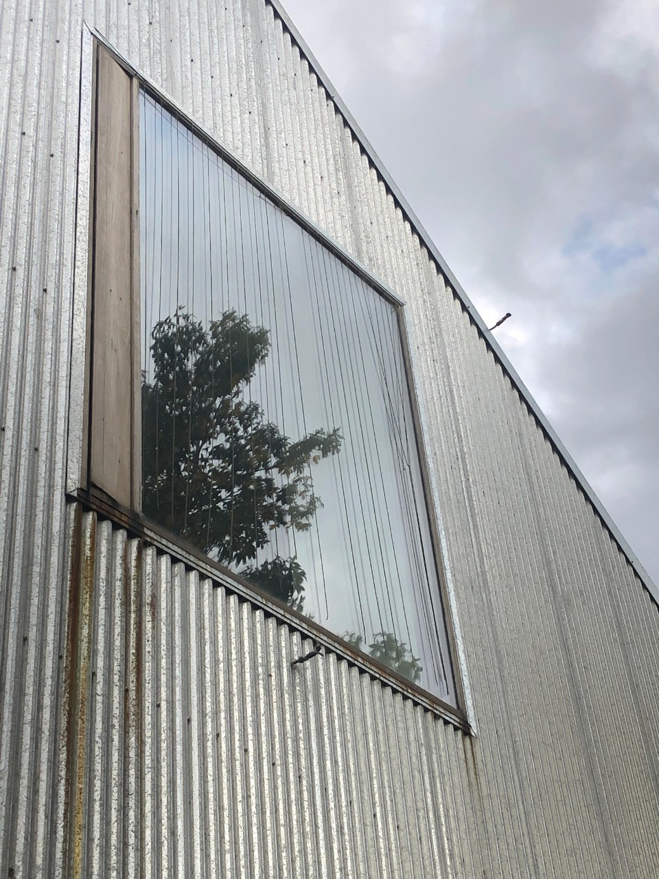 External view of curtains draped over a window.