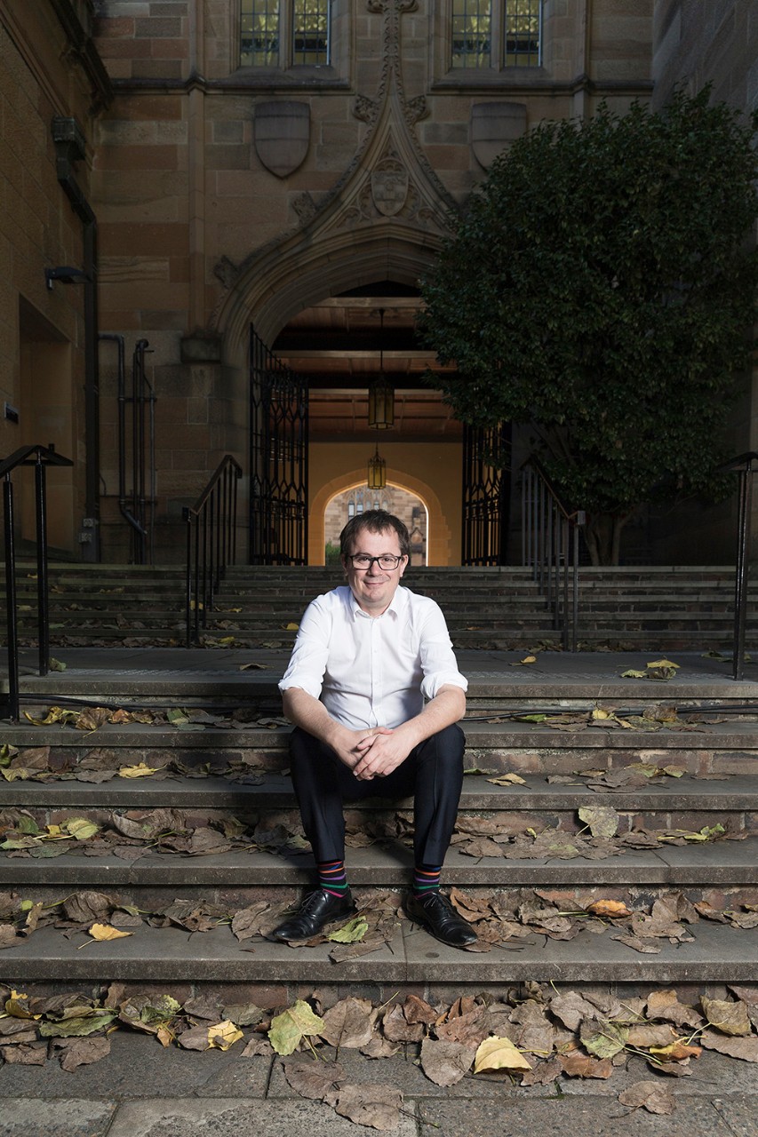 Professor Marc Stears sitting on stairs.