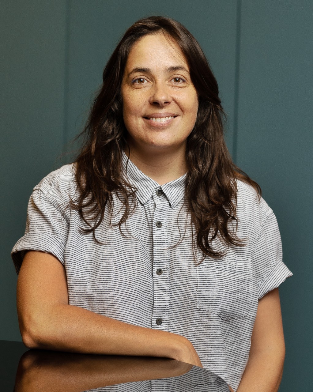 photo of a woman with long dark hair smiling