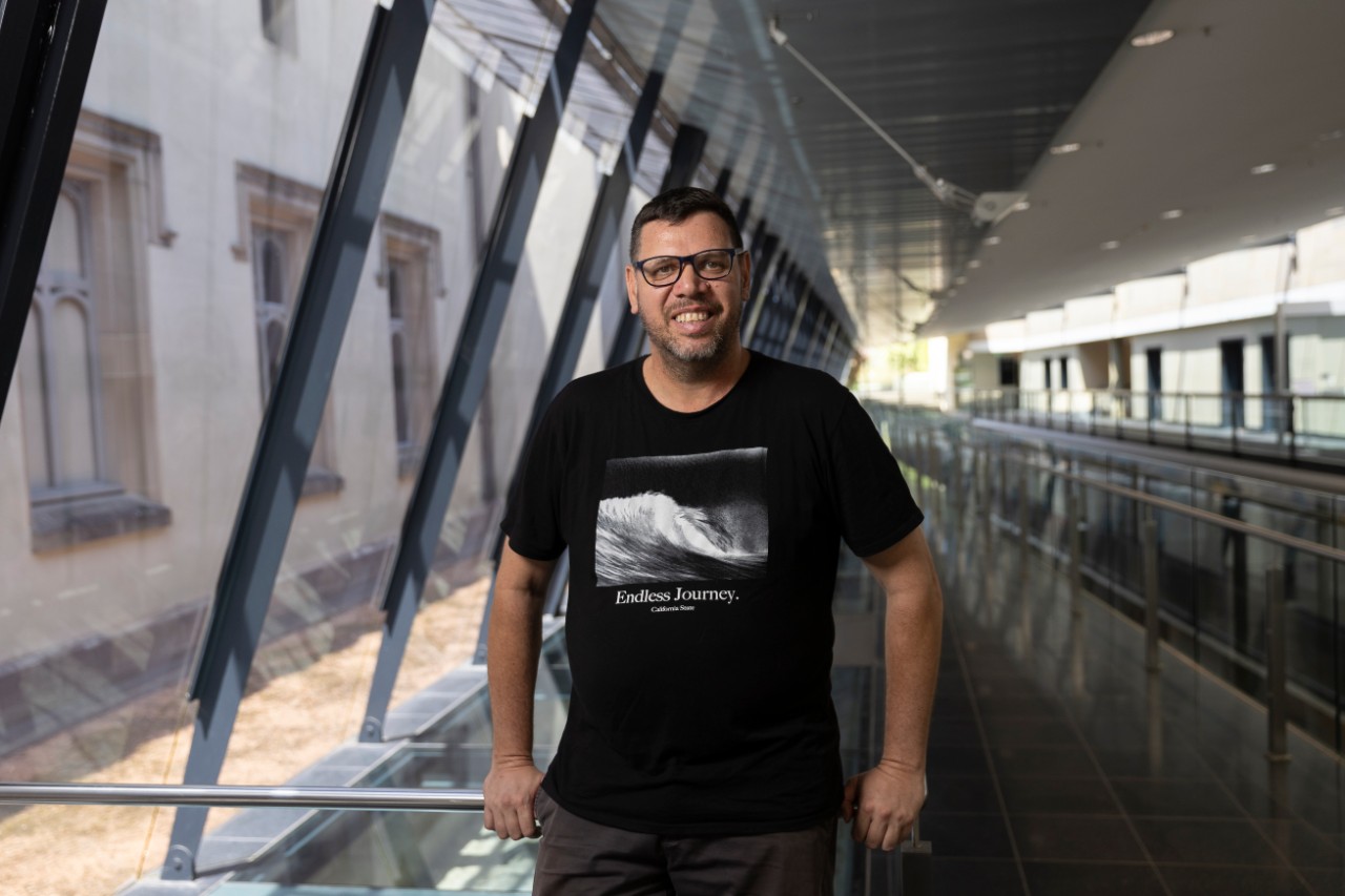 photo of Tim Gray, an indigenous man in a black tshirt smiling