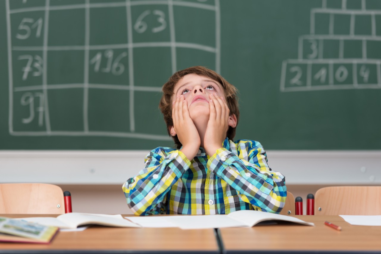 Inattentive child at a desk.