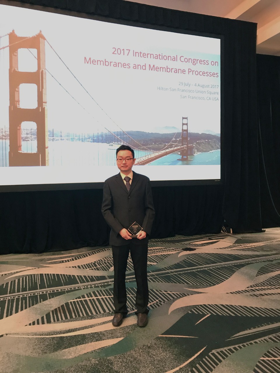 Dr Qianhong She with his award.